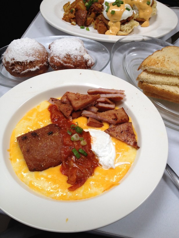 Seared Pork Belly with Cheesy Grits and Ham, Fried Catfish Eggs Benedict on Biscuits at Brenda's