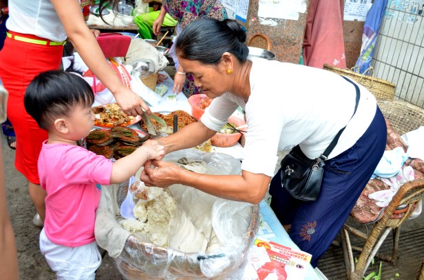 House of Haos Xishuangbanna Menghai Aini Village Market Child Buying Sticky Rice 2